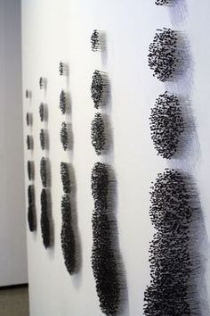 an art exhibit with black and white artwork on the wall