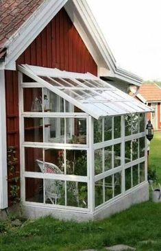 a red house with a white roof and windows