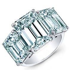 an emerald - cut diamond ring with three baguets