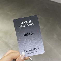 a person holding up a business card with the words hybe insight written on it