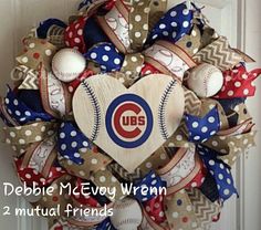 a baseball wreath with the chicago cubs on it is hanging on a front door,