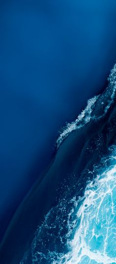 an aerial view of the ocean with waves