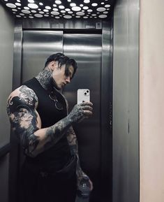 a man taking a selfie in an elevator