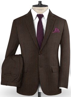 Inject luxurious and timeless style into your suit collection with our Caccioppoli Dapper Dandy Pinoza Brown Wool Suit. Crafted from 100% extrafine wool, the alternating red and blue stripes highlight the herringbone design of the brown suit to ensure that you'll never look flat at work. Complete the look by pairing it up with matching waistcoat, white shirt, maroon tie and dark brown shoes. 
 
 Look Includes  Caccioppoli Dapper Dandy Pinoza Brown Wool Fabric  Two Button Jacket Style  Notch Lape Brown Wool Suit, Maroon Tie, Grey Tweed Suit, Herringbone Tweed Jacket, White Linen Suit, Green Velvet Jacket, Peaky Blinders Suit, Royal Blue Suit, Dark Brown Shoes