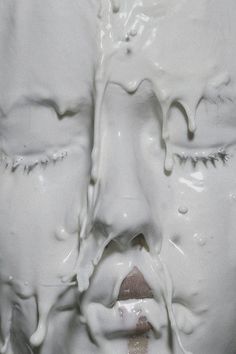 a close up of a statue with white paint on it's face and mouth