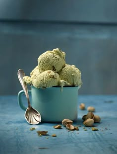 a blue cup filled with ice cream and nuts