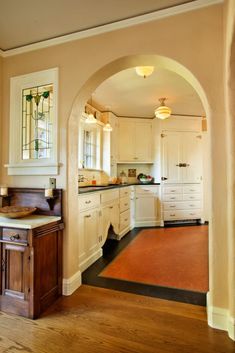 Carter-Low Kitchen - Restoring History Arched Doorway, Table Vintage, White Cabinets