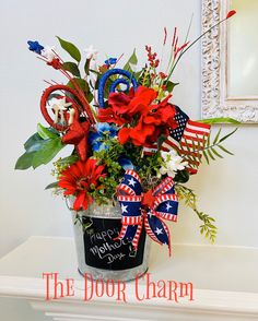 a bucket filled with red, white and blue flowers