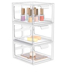 three tiered clear plastic storage container with four bottles and two trays on each side