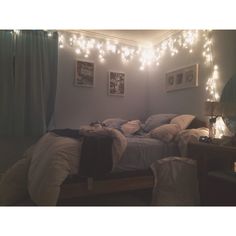 a bedroom with lights strung from the ceiling