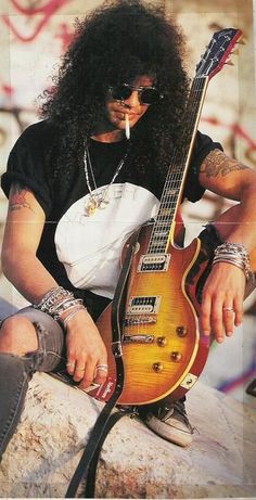 an old photo of slash with his guitar