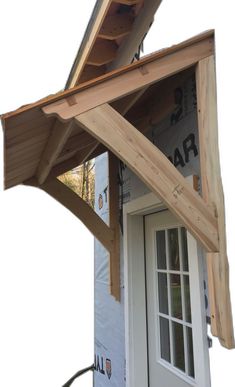 a wooden roof on top of a white door