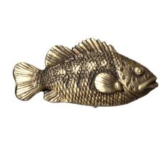 a gold colored fish figurine on a white background