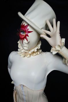 a mannequin wearing a white hat with red flowers on it's face