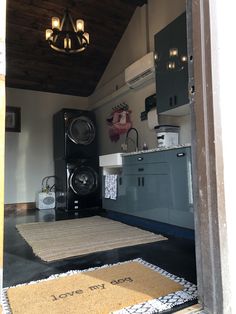 a washer and dryer in a small room with a rug on the floor