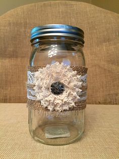 a mason jar filled with lace and flowers