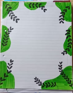 a piece of paper with green leaves on it and lined in sheets of white paper