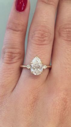 a woman's hand with a diamond ring on it