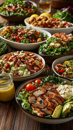 a table topped with lots of plates filled with different types of food and salads