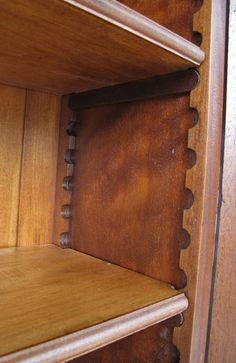 a wooden shelf with two shelves on each side