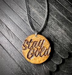 a wooden necklace with the word soul soul on it