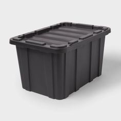 a black plastic container with wheels on the bottom and sides, in front of a white background