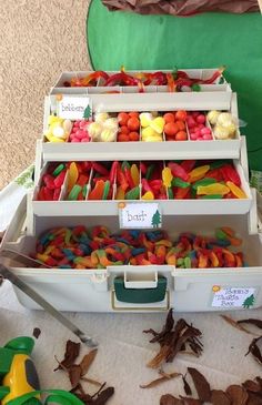 three bins filled with different types of candies on top of a white table