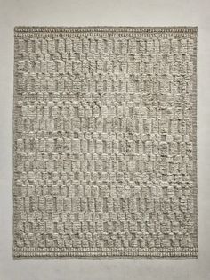 an image of a square rug made out of woven material on a wall with white walls