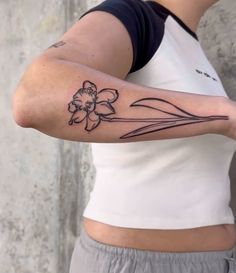 a woman with a flower tattoo on her arm