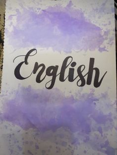 the word english written in black ink on a piece of paper with purple and white paint