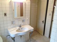 a white bathroom sink sitting under a mirror