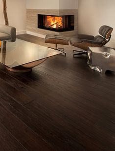 a modern living room with wood floors and a fireplace