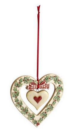 a ceramic heart ornament hanging from a red ribbon