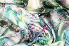 Experience elegance with our luxurious Italian silk charmeuse fabric. Soft and with a light, fluid drape, this fabric is perfect for any special occasion. The unique and vibrant tie-dye print adds a touch of originality, making a statement piece for any wardrobe. Bohemian Silk Scarf With Batik Print, Elegant Green Floral Print Silk Scarf, Elegant Green Floral Silk Scarf, Elegant Multicolor Silk Scarf For Wedding, Green Silk Scarf For Party, Bohemian Satin Silk Scarf For Summer, Silk Scarf For Party In Spring, Silk Scarf For Spring Party, Spring Satin Silk Scarf With Satin Finish