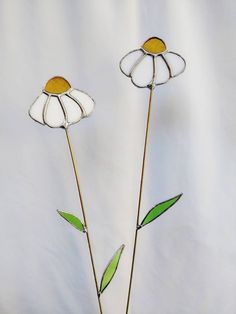 two stained glass flowers with green stems in a vase