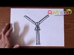 someone is drawing a windmill on paper with their hand and the word articoo written in