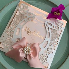 a pink and gold wedding card with a bow