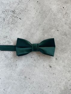 "Choose between one of these popular 2022 wedding colors. These \"Gem\" satin silk items are perfect colors for mix and matching groom , groomsmen and ring bearer. Sold individually. BOW TIE SIZE MEASUREMENTS KIDS (approx 2-10 years old): measures 4\" x 2\" TEEN/ADULT (approx 11+ years old): measures 4.5\" x 2.5\" NECK TIE MEASUREMENTS 2.50\" X 58\"" Dapper Suit And Tie Accessories For Wedding, Dapper Solid Color Wedding Ties, Dapper Solid Color Tie For Wedding, Dapper Wedding Tie In Solid Color, Dapper Wedding Tie, Wedding Ties With Satin Finish, Satin Bow Tie For Groom, Wedding Satin Ties With Satin Finish, Green Satin Bow Tie For Wedding