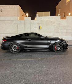 a black sports car parked in front of a building