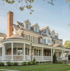 a large white house sitting on top of a lush green field