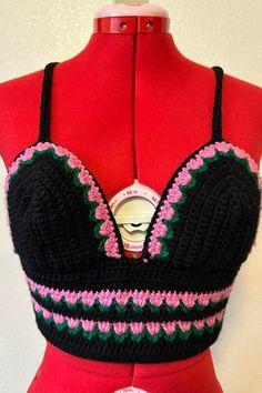 a woman's bra top with crochet and buttons on the front, attached to a mannequin torso