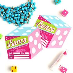 some dices and beads on a table with bunco night out tags attached to them