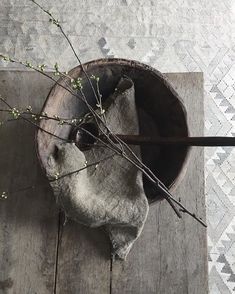 an old wooden bowl with branches in it