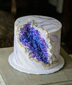 a white cake with purple and blue frosting