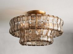 a glass light fixture hanging from the ceiling