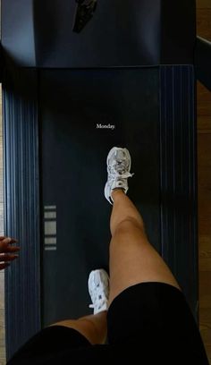 a person standing on top of a machine with their feet propped up in front of it