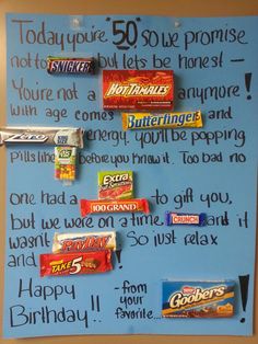 a bulletin board with candy bars on it and some words written on the wall above them