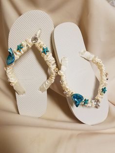 "Very beautiful Flat wedding sandals flipflop style 1/2\" heel. With beautiful workmanship, I used real shells, glass pearls, crystals, beads, pearl star fishes, and ceramic star fishes, plus more. Very dressy and simple please look at the pictures. Sizes: Small: 5.5 - 6.5 Medium: 7-8 Large: 8.5 - 9.5, X-Large: 10 - 11 Children sizes available upon request, please contact for details. Please contact for any questions ON SIZING, or ANY other concerns. FINAL SALE, NO RETURNS, NO EXCHANGES, NO EXCE White Wedding Sandals For Beach Season, Adjustable Open Toe Flip Flops For Beach Wedding, Blue Beaded Open Toe Sandals, White Beaded Open Toe Sandals, White Beaded Wedding Sandals, Starfish Sandals Blue Embellished, Flat Sandals Wedding, Beaded Flat-heel Sandals For The Beach, Lace Barefoot Sandals