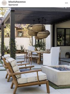 an outdoor dining area with chairs, table and fire pit