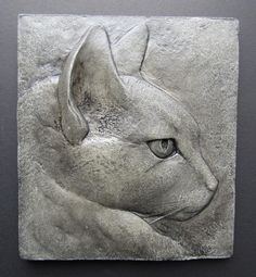 a close up of a cat's face on a tile